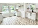 Bright, all-white kitchen featuring modern cabinetry, butcher block counters, and abundant natural light at 3712 S Kealing S Ave, Indianapolis, IN 46237