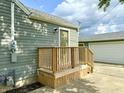 Home exterior featuring a separate entrance and a detached garage at 405 E Cowing Dr, Muncie, IN 47303