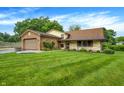 Charming home boasts a brick-and-siding facade, lush lawn, attached garage, and colorful landscaping at 4070 Serenity Way Ct, Greenwood, IN 46142