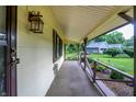 Inviting covered porch with decorative railing offers a view of the landscaped yard and neighborhood at 4070 Serenity Way Ct, Greenwood, IN 46142