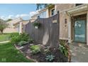 Beautifully landscaped front yard with a dark wooden fence and charming curb appeal at 5152 Coppertree Ln, Avon, IN 46123