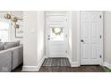 Bright foyer features a decorative mat and front door with glass inserts at 519 Sutherland Ave, Indianapolis, IN 46205
