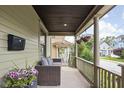 Inviting front porch features cozy seating and decorative hanging flower baskets at 519 Sutherland Ave, Indianapolis, IN 46205