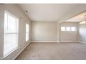Bright and airy living room with neutral walls, large windows with blinds, and soft carpeting at 6218 N Woodside Ct, McCordsville, IN 46055