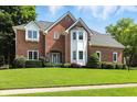 Stunning two-story brick home featuring a well-manicured lawn and inviting curb appeal at 6316 Harmonridge Ct, Indianapolis, IN 46278