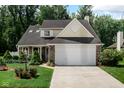 Charming home with a two-car garage, well-manicured lawn, and inviting curb appeal at 6439 Bower Dr, Indianapolis, IN 46241
