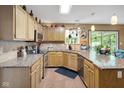 Bright kitchen featuring granite countertops, wooden cabinets, and stainless steel appliances at 6439 Bower Dr, Indianapolis, IN 46241