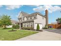 The two-story home displays a clean exterior with a brick chimney, well-kept lawn, and a two-car garage at 6622 W Dickens Xing, McCordsville, IN 46055