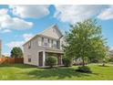 Charming two-story home with brick accents, shutters, and a well-manicured lawn on a sunny day at 6622 W Dickens Xing, McCordsville, IN 46055