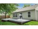 Spacious backyard deck, perfect for outdoor entertaining and relaxation, with a landscaped yard at 6816 Minnow Dr, Indianapolis, IN 46237