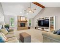 Open living room featuring a brick fireplace, large windows, and built-in entertainment center at 770 Viewpoint Dr, Plainfield, IN 46168