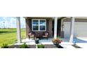 Charming front porch with brick accents, decorated with plants and patio furniture at 7808 Grande Oaks Dr, Plainfield, IN 46168
