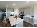 Bright kitchen featuring stainless appliances, a center island with seating, and modern cabinetry at 7808 Grande Oaks Dr, Plainfield, IN 46168