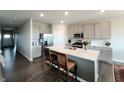 Modern kitchen with stainless steel appliances, a large island, and gray cabinets at 7808 Grande Oaks Dr, Plainfield, IN 46168