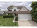 Two-story home with green shutters, well-manicured lawn and an attached two car garage at 7914 Willow Wind Cir, Indianapolis, IN 46239