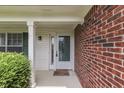 Close-up of a well-maintained front entrance with a white-framed door and brick accents at 7914 Willow Wind Cir, Indianapolis, IN 46239