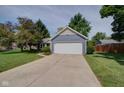 Inviting exterior featuring well-kept lawn, driveway, and a two-car garage with blue siding at 9170 Andiron Way, Indianapolis, IN 46250