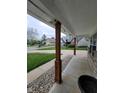 View from the porch that features stone trim and wooden beams, looking out into the neighborhood at 922 Eagle Brook Dr, Shelbyville, IN 46176
