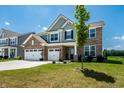 Beautiful two-story home with brick and siding exterior, a spacious front yard, and an attached three-car garage at 9407 Casey Rd, Pendleton, IN 46064