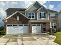 Charming two-story brick home featuring a three-car garage, manicured lawn and neutral colored siding at 9407 Casey Rd, Pendleton, IN 46064