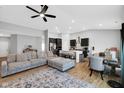 Open-concept living space featuring a cozy couch, modern kitchen with island seating, and an adjacent dining area at 9858 Bryce Blvd, Pendleton, IN 46064