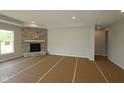 Spacious living room with a stone fireplace and a large window at 10424 Oak Bend Blvd, Indianapolis, IN 46239