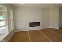 Bright living room featuring large windows and a modern electric fireplace at 10602 Maidenhair Dr, Indianapolis, IN 46239