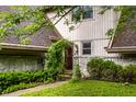 Inviting front entrance with a lush, green archway over the walkway leading to the front door at 11544 Crestwood Ct, Indianapolis, IN 46239