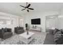 Bright living room featuring a ceiling fan, neutral color palette, and comfortable seating arrangement at 12121 Driftstone Dr, Fishers, IN 46037