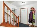 Bright entryway featuring a staircase with wooden banister, a white door, and a convenient coat rack at 1224 S Hunter Rd, Indianapolis, IN 46239