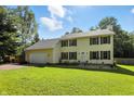 Traditional two-story home with an attached garage, black shutters, and a neatly landscaped front yard under a sunny sky at 1224 S Hunter Rd, Indianapolis, IN 46239