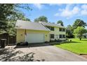 Well-maintained two-story home with an attached garage, a manicured lawn, and a classic colonial-style exterior at 1224 S Hunter Rd, Indianapolis, IN 46239