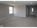 Spacious bonus room with neutral carpet, recessed lighting, and ample natural light from a side window at 12400 French Cattle Way, Noblesville, IN 46060