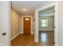 Inviting entryway showcasing beautiful wood floors, a charming wood door and light gray walls at 12661 Doe Ln, Indianapolis, IN 46236