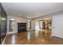 Spacious living room with a cozy fireplace, hardwood floors, and abundant natural light at 12661 Doe Ln, Indianapolis, IN 46236