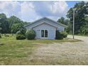 Light gray building with green lawn and parking area with some trees surrounding at 1267 W 750 S, Trafalgar, IN 46181