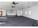 Expansive carpeted meeting room with modern lighting fixtures and bright white walls at 1267 W 750 S, Trafalgar, IN 46181