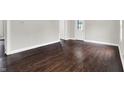 Spacious living room with hardwood flooring, neutral gray walls, and a bright white trim with natural lighting at 1418 W 5Th St, Anderson, IN 46016