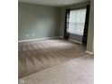 Inviting living room featuring neutral carpet, light green walls, and a large window offering natural light at 14375 Leland Muse, Fishers, IN 46037