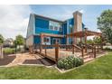 A spacious backyard with a wooden deck, pergola, blue siding and a cozy outdoor space at 1521 Midnight Pass, Brownsburg, IN 46112