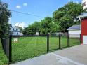 Fenced backyard with established trees and a large grass area at 160 E Elm St, Morgantown, IN 46160