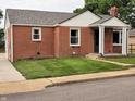 Brick home with well-kept lawn and landscaping, featuring bright white trim at 160 E Elm St, Morgantown, IN 46160