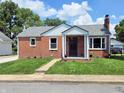 Traditional brick house with a well-manicured lawn and inviting walkway, situated on a sunny street at 160 E Elm St, Morgantown, IN 46160