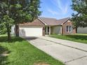 Charming brick home with a two-car garage and an extra long driveway at 1702 Juniper Ln, Greenwood, IN 46143