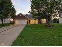 Charming brick home with a two-car garage, well-maintained lawn, and inviting curb appeal at 1702 Juniper Ln, Greenwood, IN 46143