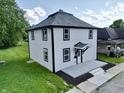 Aerial view of a two-story home with landscaping and a fresh concrete walkway at 1809 S H St, Elwood, IN 46036