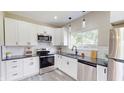 Bright kitchen with white cabinets, stainless steel appliances, and granite countertops at 1809 S H St, Elwood, IN 46036