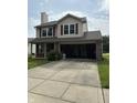 Two-story home with a brick and vinyl exterior, attached garage, and concrete driveway at 19236 Fox Chase Dr, Noblesville, IN 46062