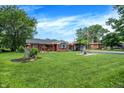 Well-maintained single-story home with a lush front yard and a covered parking area at 3038 S Richardt Ave, Indianapolis, IN 46239