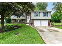 A well-kept two-story home with a two-car garage, neat landscaping, and inviting blue shutters at 317 Heritage Ct, Fishers, IN 46038